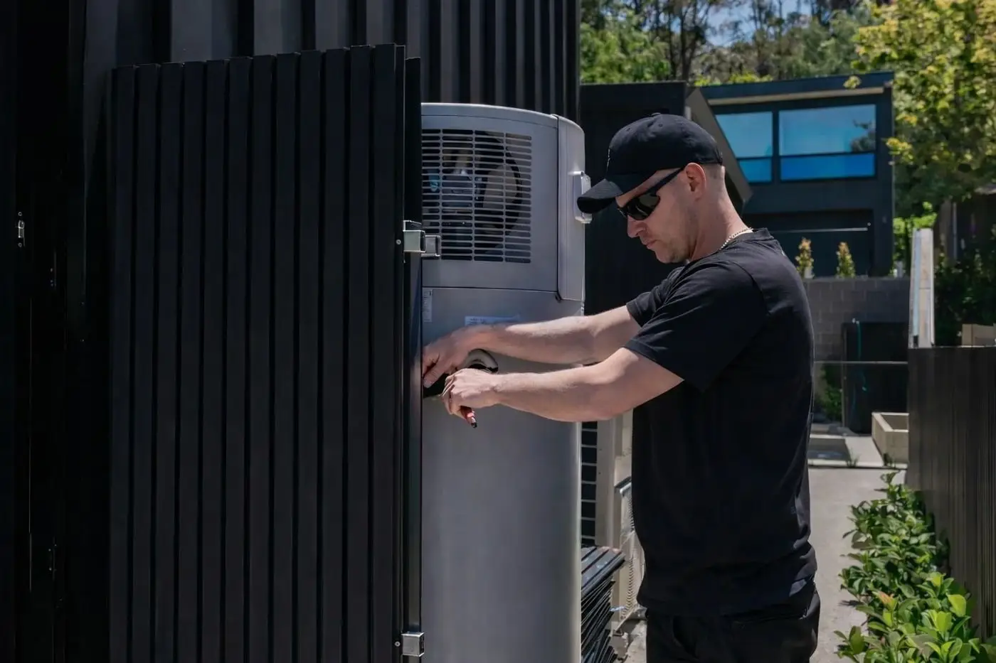 Plumber connecting a heat pump hot water system