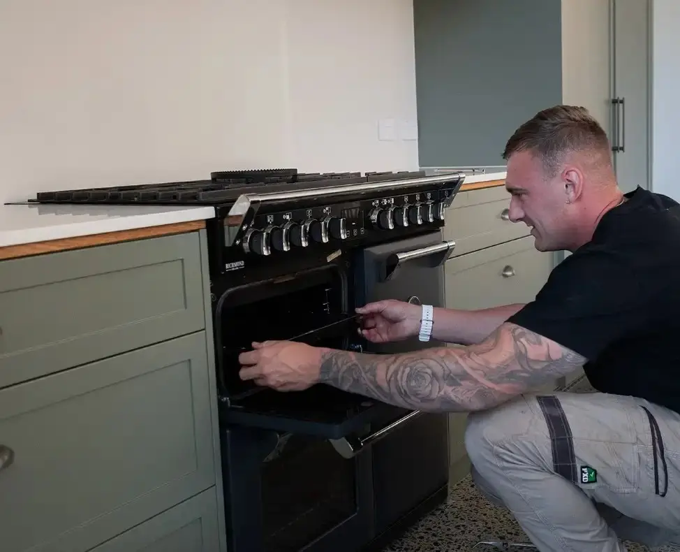 Steven Seery checking a newly installed gas oven